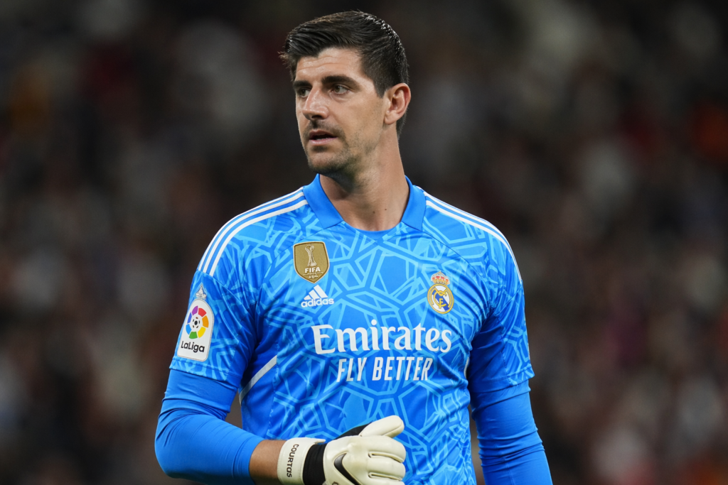 Thibaut Courtois w koszulce Realu Madryt podczas meczu, skupiony na grze, stadion w tle