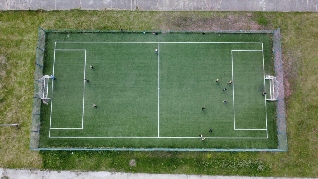 Aerial view of a soccer game on a green field in Krasnoyarsk Krai, Russia.